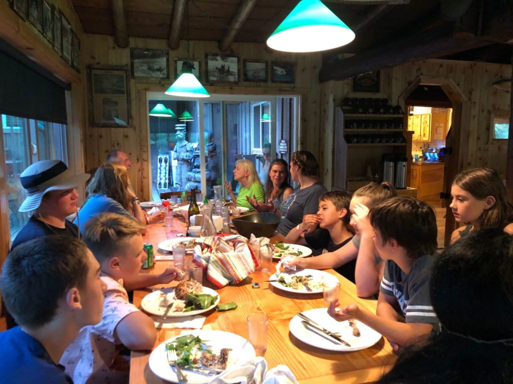 group eating dinner on custom rafting trip