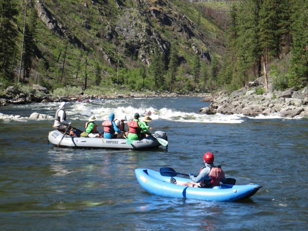 Oar/paddle raft about to run rapid with inflatable kayak following behind